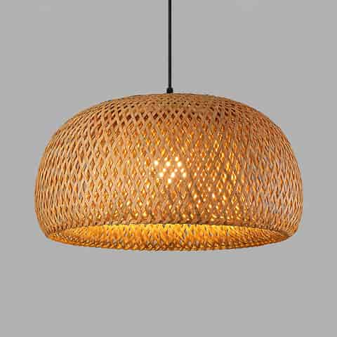 Illuminated double layer bamboo pendant light with warm glow through woven dome shade